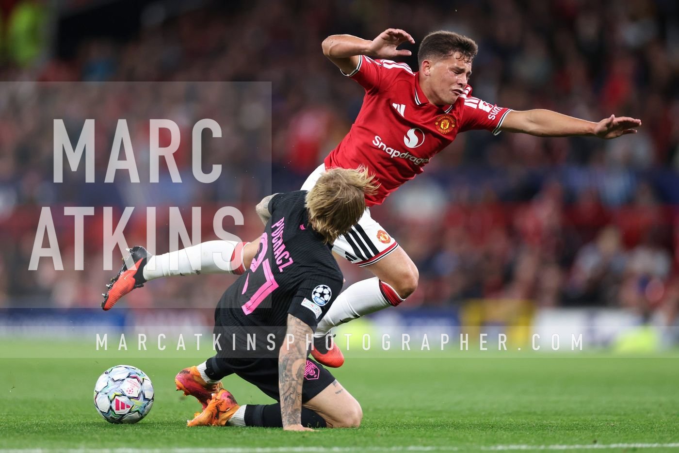 Shea Lacey of Manchester United in action with Tymoteusz Puchacz of Sabah FK