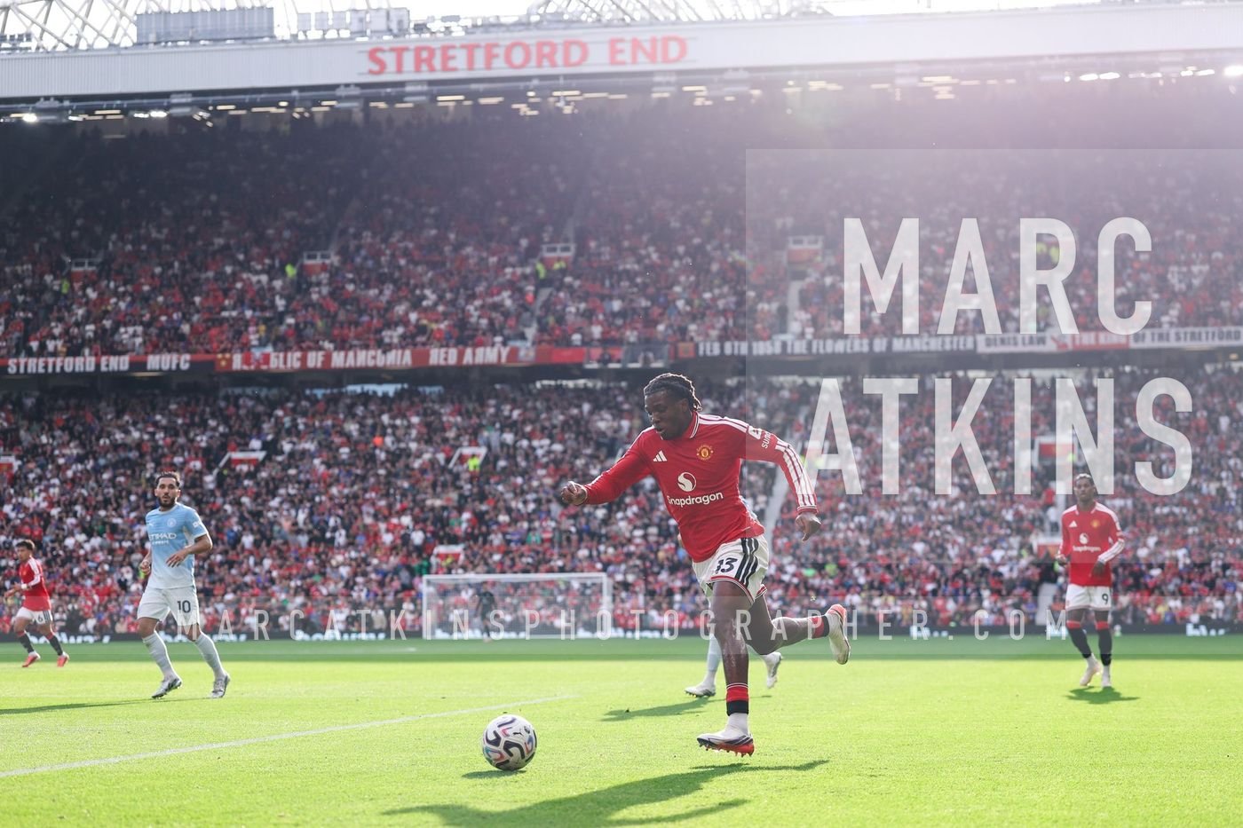 A general view of the Stretford End as Patrick Dorgu of Manchester United runs with the ball